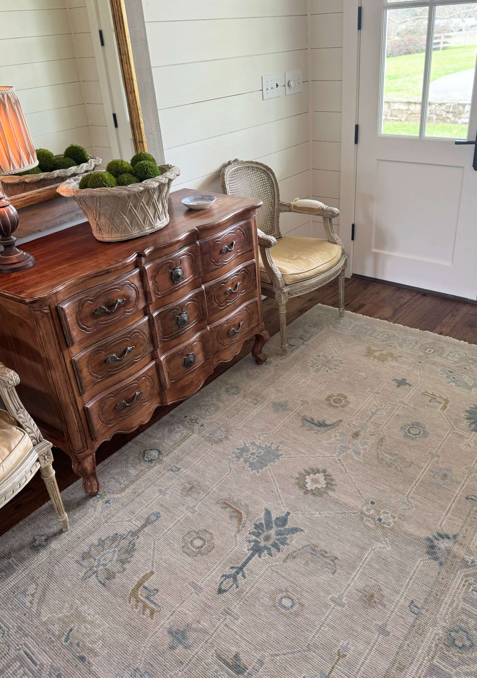 Neutral Modern Oushak with blues that is hand knotted in foyer in Alabama.