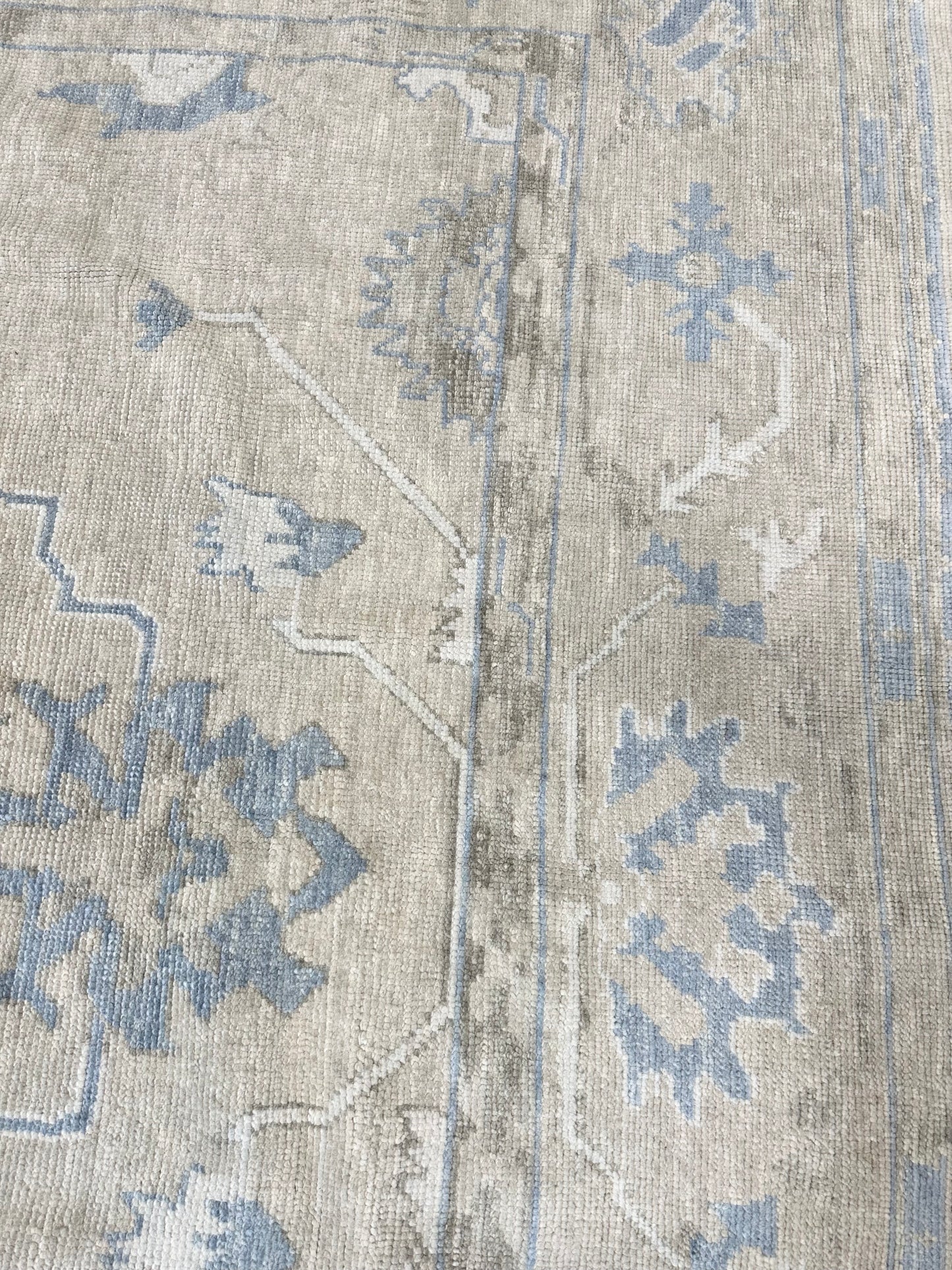 Neutral Turkish hand-knotted wool modern oushak with accents of brown, blue, and cream.