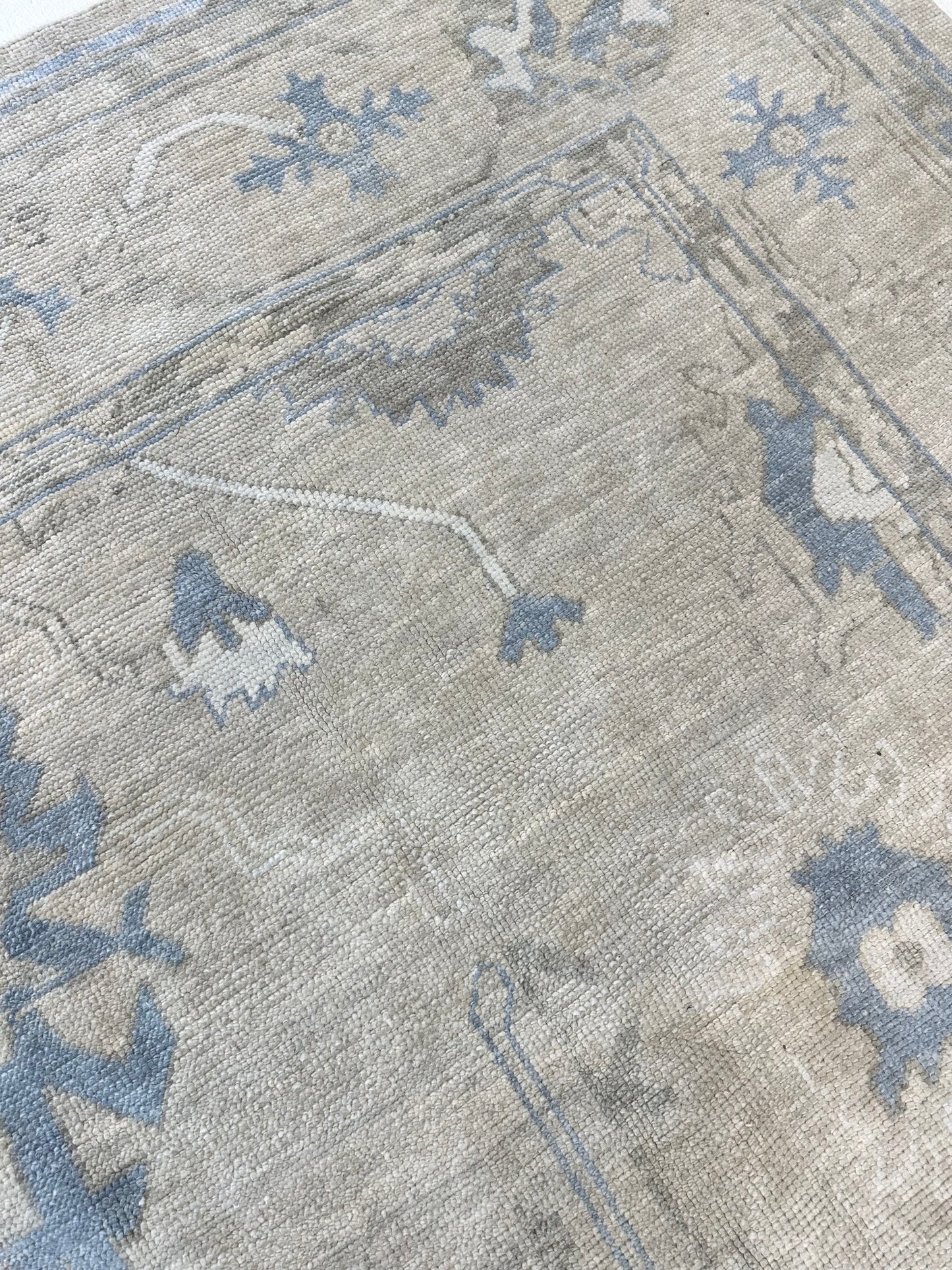 Neutral Turkish hand-knotted wool modern oushak with accents of brown, blue, and cream.