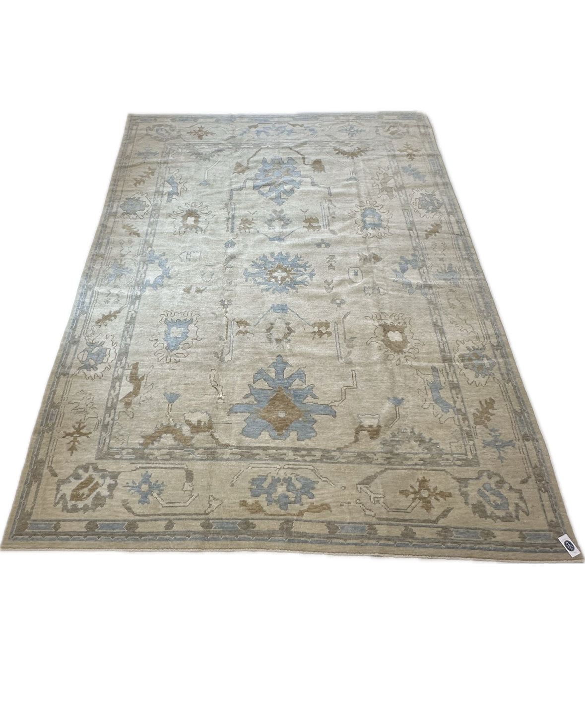 Neutral Turkish hand-knotted modern oushak with accents of sepia, blue, and cream.