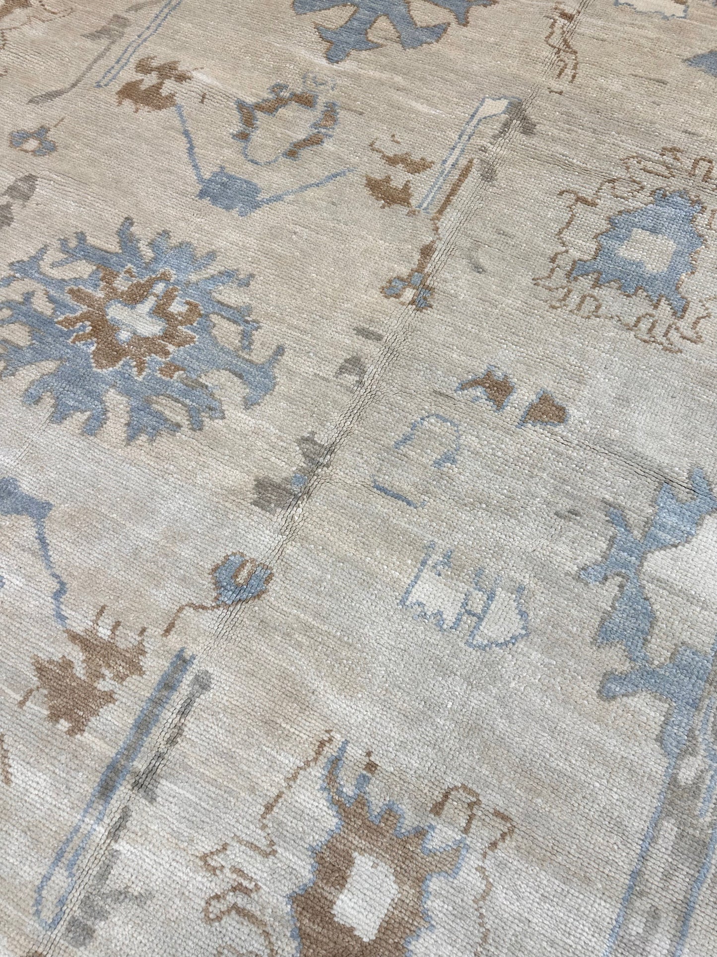 Neutral Turkish hand-knotted modern oushak with accents of sepia, blue, and cream.