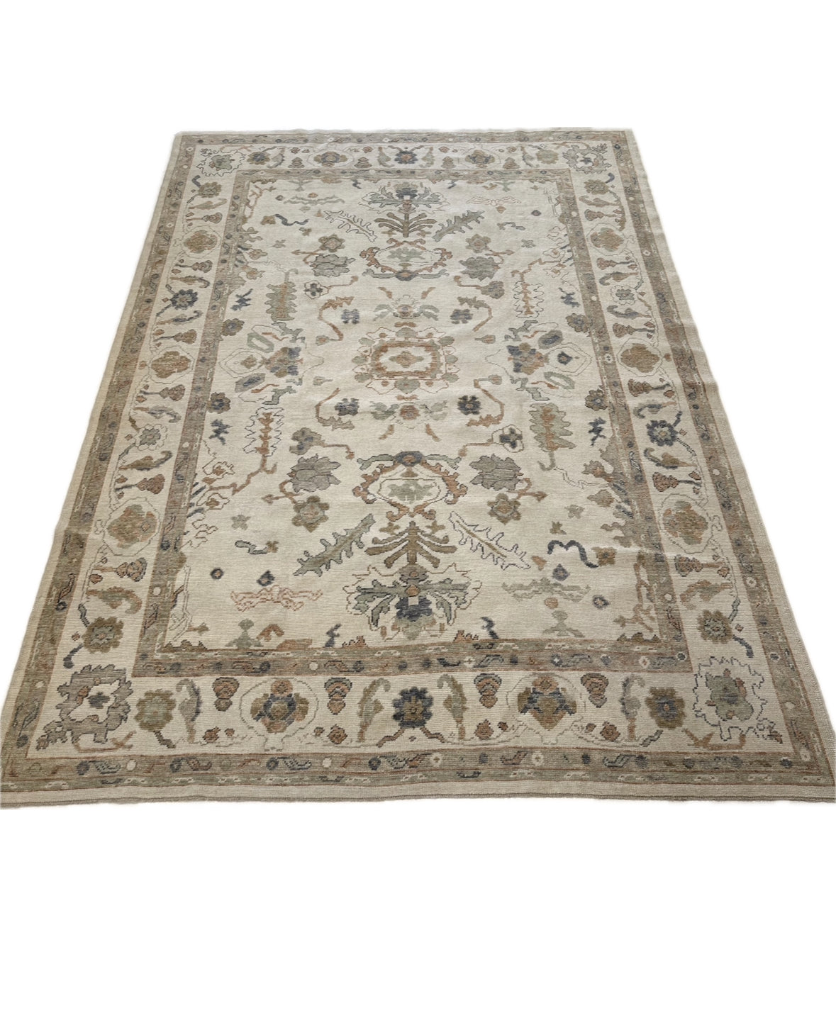 Neutral Turkish Oushak Rug with blues, greens, and oranges closeup in Fairhope, AL