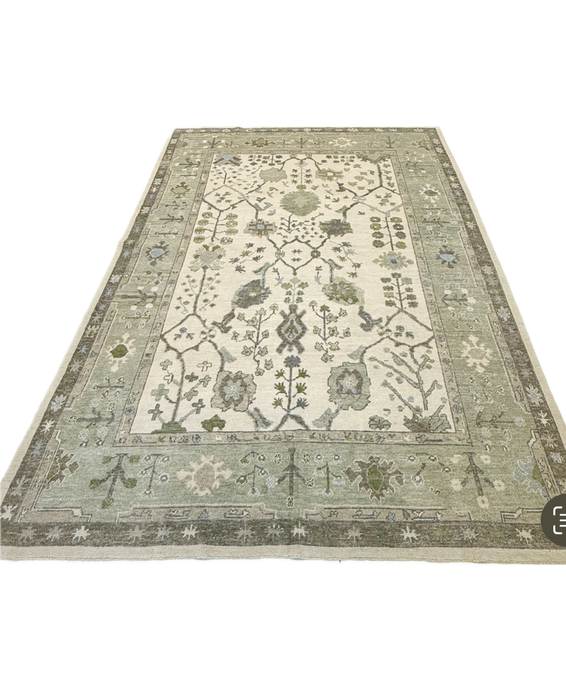 Eden turkish oushak rug with blues and green floral patterns on a neutral background in Fairhope, AL