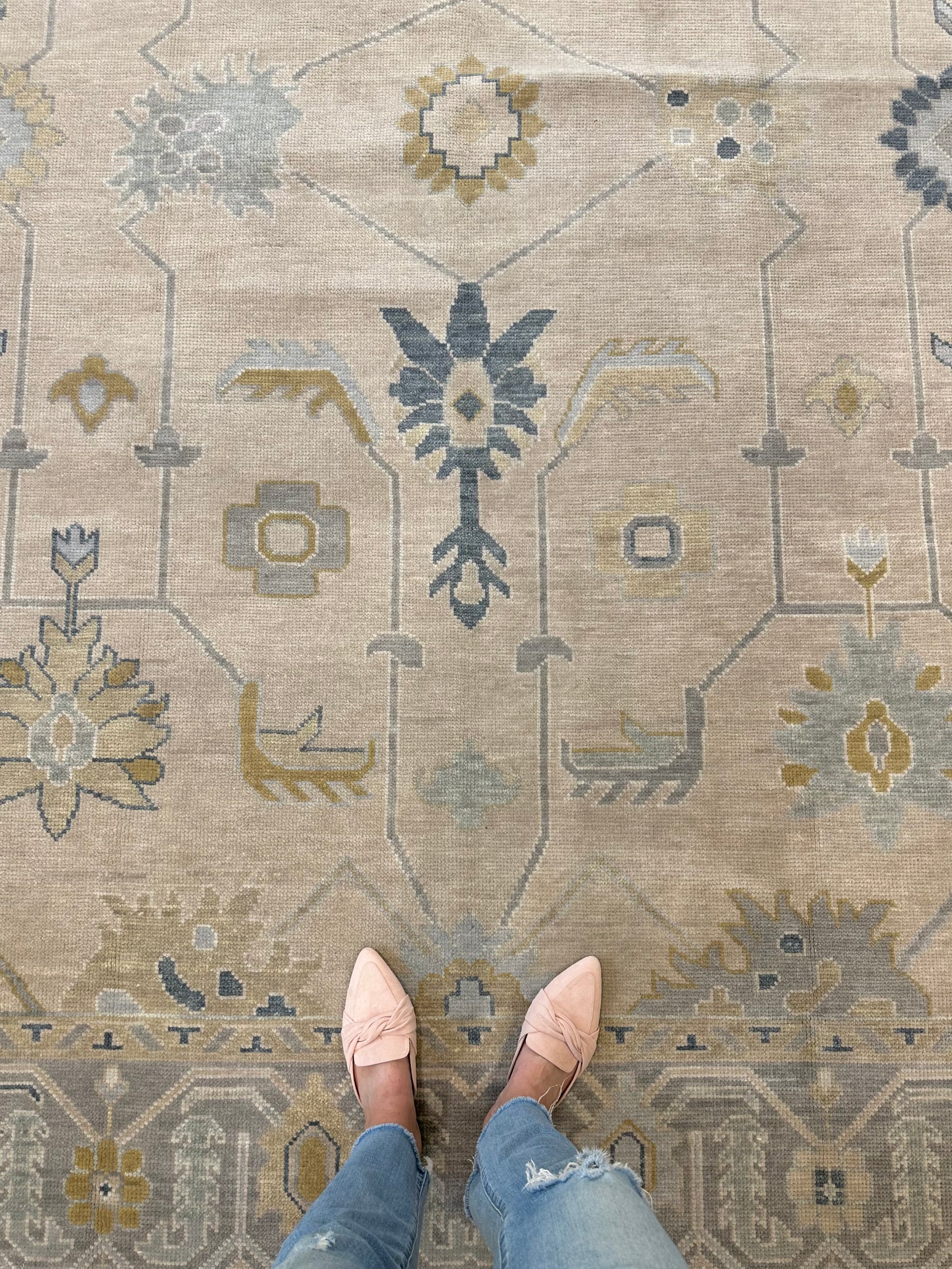 Neutral Turkish Oushak with blues that is hand-knotted.