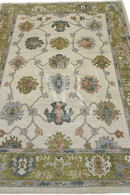 Posey hand-knotted wool Turkish Oushak rug, ivory base with chartreuse border and playful turquoise, salmon, and light blue