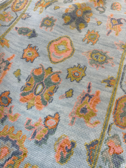Layla modern Oushak rug, hand-knotted wool with a light blue foundation and chartreuse, green, coral, and dark periwinkle accents