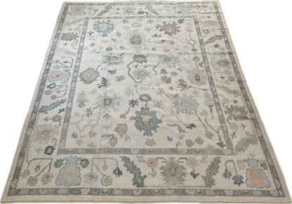 Opal off-white Turkish Oushak rug with gray undertones and green, teal, navy, and brown accents