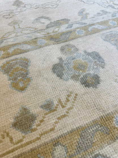 Kendal modern Oushak rug, cream background with light blue, warm tan, and soft green accents