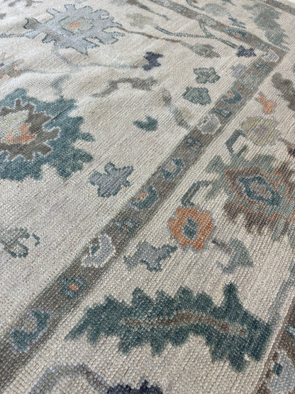 Opal off-white and gray Turkish Oushak rug with green, teal, orange, and navy accents, hand-knotted wool
