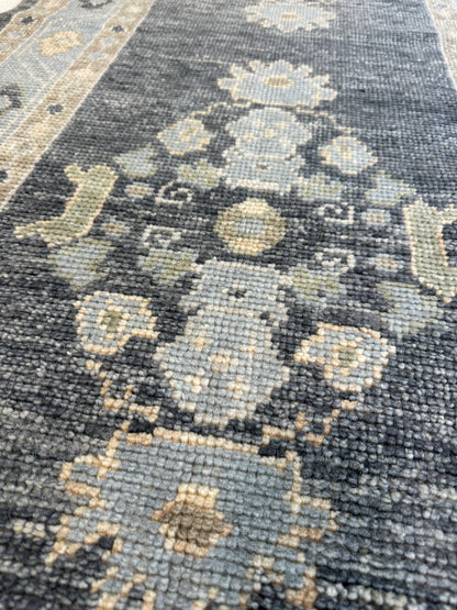 Harriet hand-knotted wool Turkish Oushak rug in navy with green, tan, and cream
