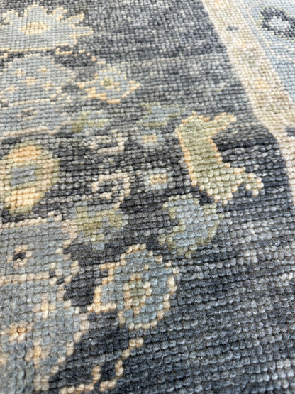 Harriet hand-knotted wool Turkish Oushak rug in navy with green, tan, and cream