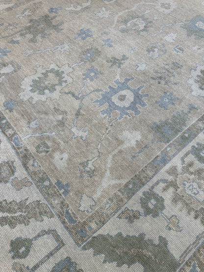 Close-up of Frances Turkish Oushak rug showing neutral cream, blue, light green, brown, hand-knotted wool