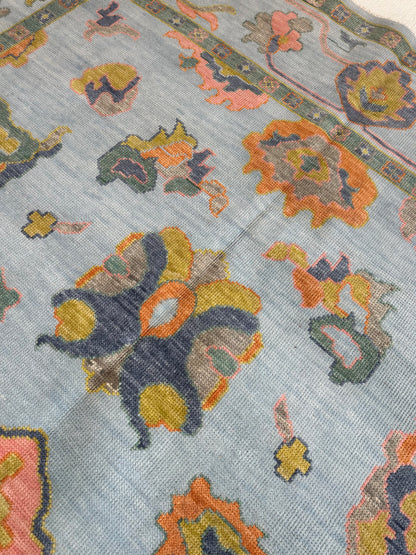 Layla light blue modern Oushak rug with chartreuse, green, coral, and periwinkle accents, hand-knotted wool