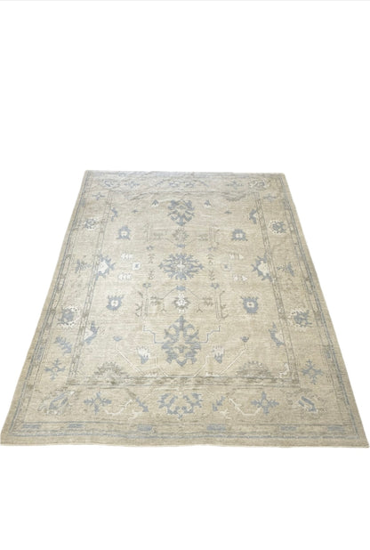 Neutral Turkish hand-knotted wool modern oushak with accents of brown, blue, and cream.
