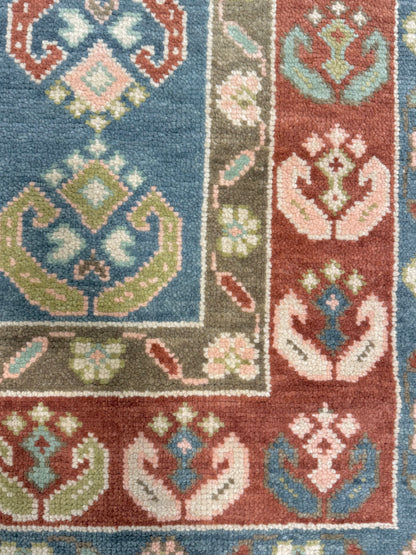 Charlotte Modern Oushak rug — hand-knotted wool in blue with medium blue, olive, rust, blush, mint green, light green