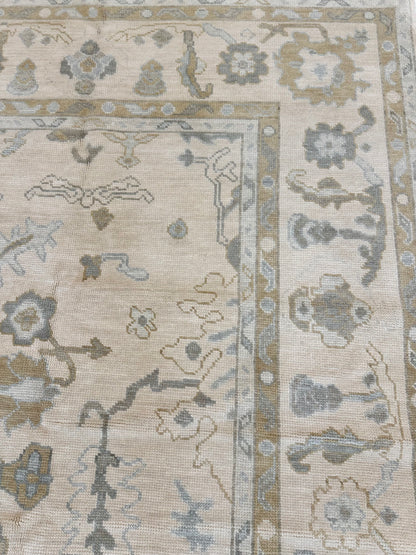 Kendal modern Oushak rug, hand-knotted wool with a cream background and light blue, warm tan, soft brown, and light green accents