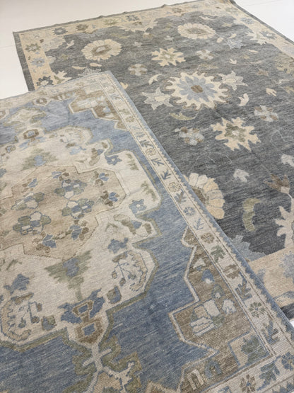 Evelyn Turkish Oushak rug styled in a room, deep gray-blue, cream, warm tan, light blue, light green, hand-knotted wool