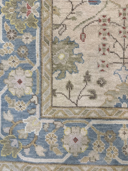 Willa beige modern Oushak rug with olive, gray-blue, taupe, red, and yellow accents, hand-knotted wool