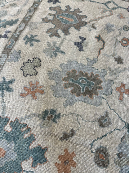 Opal hand-knotted wool Turkish Oushak rug in off-white with gray undertones and green, teal, and navy tones