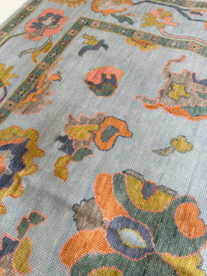 Layla modern Oushak rug, light blue with playful chartreuse, green, coral, and dark periwinkle accents
