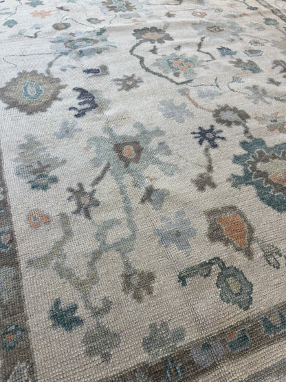Opal Turkish Oushak rug, off-white with green, teal, orange, navy, and brown accents