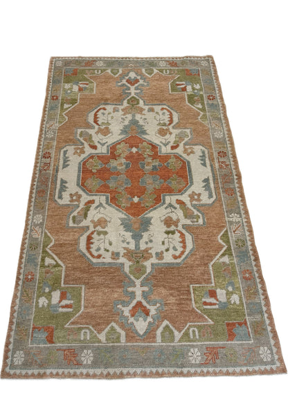 Close-up of Chelsea Turkish Oushak rug showing coral-orange, rust, bright blue, apple green, ivory, warm gray, hand-knotted wool