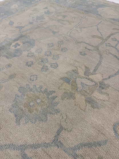 Ophelia warm neutral and light blue modern Oushak rug with sage green, brown, and cream accents