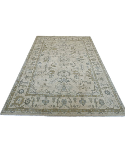 Kendal hand-knotted wool modern Oushak rug, warm cream with blue, tan, brown, and green tones
