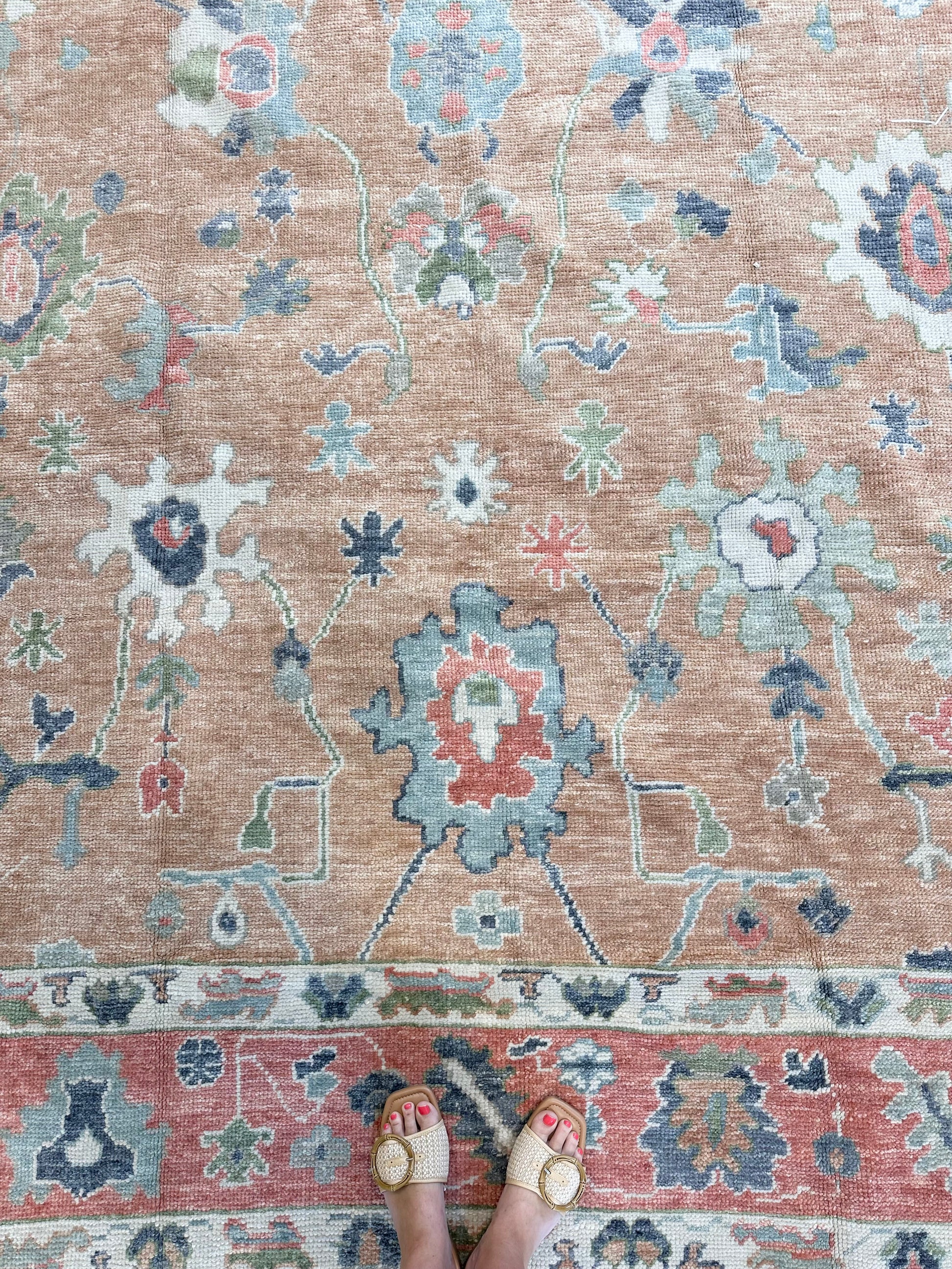 Beautiful hand-knotted wool Turkish modern oushak that is orange with accents of blue, green, navy, tomato red and cream.