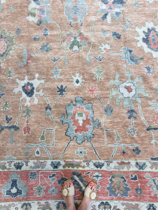 Beautiful hand-knotted wool Turkish modern oushak that is orange with accents of blue, green, navy, tomato red and cream.