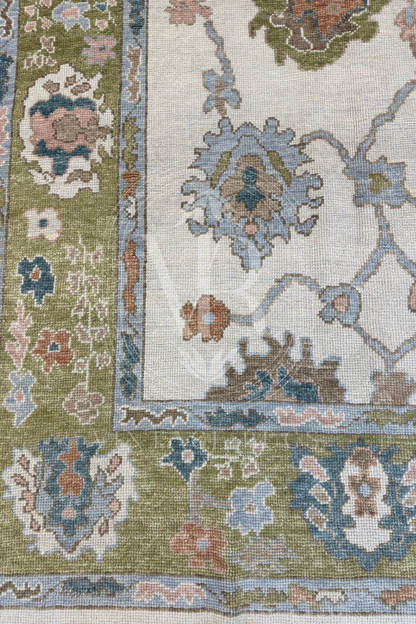 Posey ivory Turkish Oushak rug with a chartreuse border and turquoise, salmon, light blue, and brown accents, hand-knotted wool