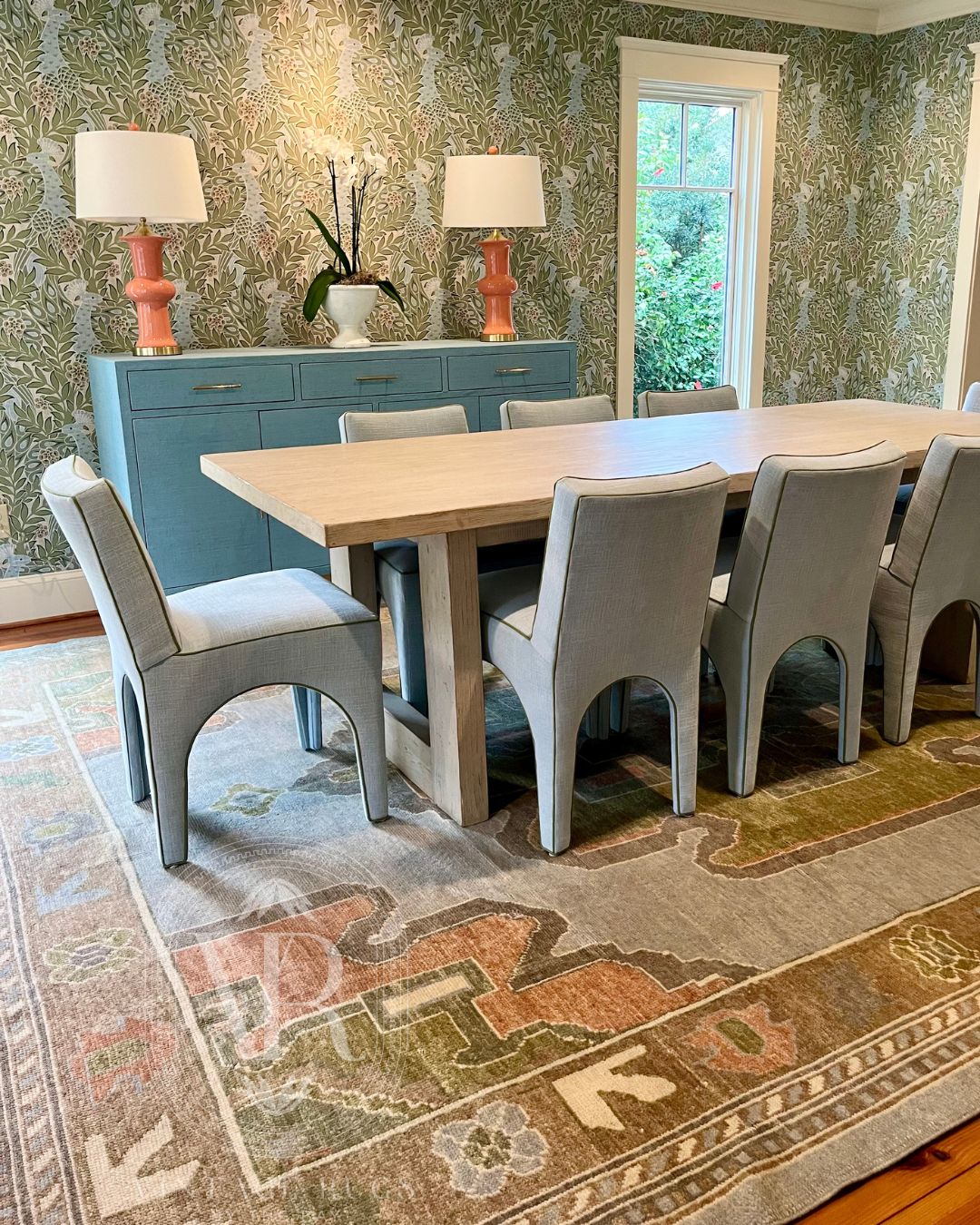 blue and green wool turkish oushak in dining rom with blue upholstered chairs