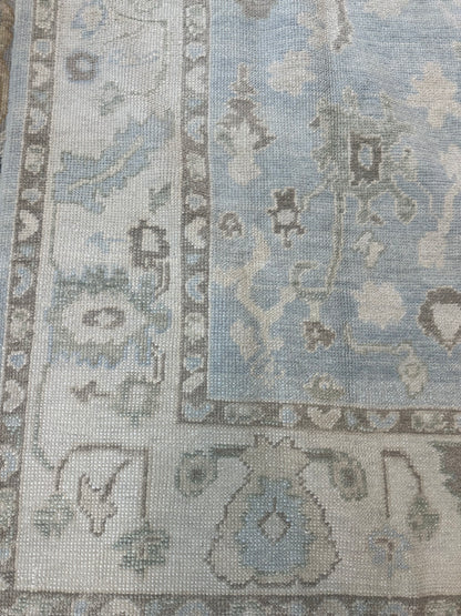 Close-up of Darcy Turkish Oushak rug showing blue, cream, warm brown, green, hand-knotted wool