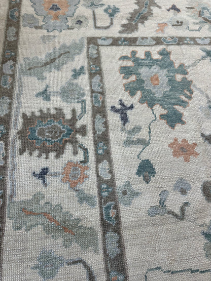 Opal hand-knotted wool Turkish Oushak rug in off-white with green, teal, orange, and navy tones