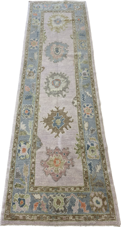 Bailey Turkish  colorful Oushak runner, full view of lavender base, blue border, pink, orange, and brown accents