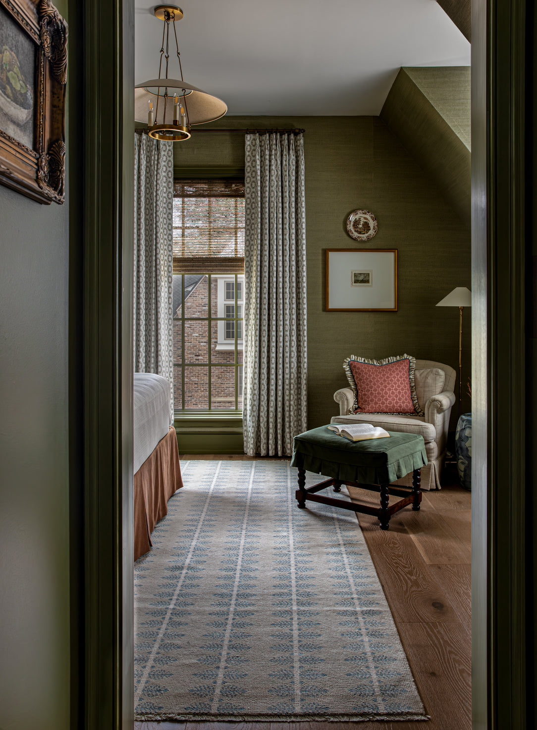 Blue and Tan modern ouhsak rug in Green bedroom with traditional design and red accents.