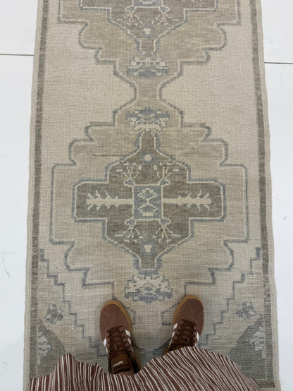 Bethany Blue Turkish oushak rug — warm gray foundation with tan, cool brown, and soft gray-blue accents, hand-knotted 100% wool area rug