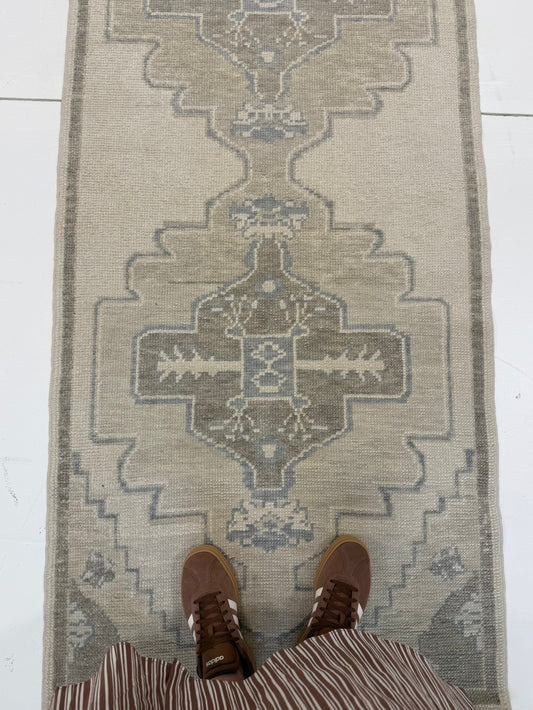 Bethany Blue Turkish oushak rug — warm gray foundation with tan, cool brown, and soft gray-blue accents, hand-knotted 100% wool area rug