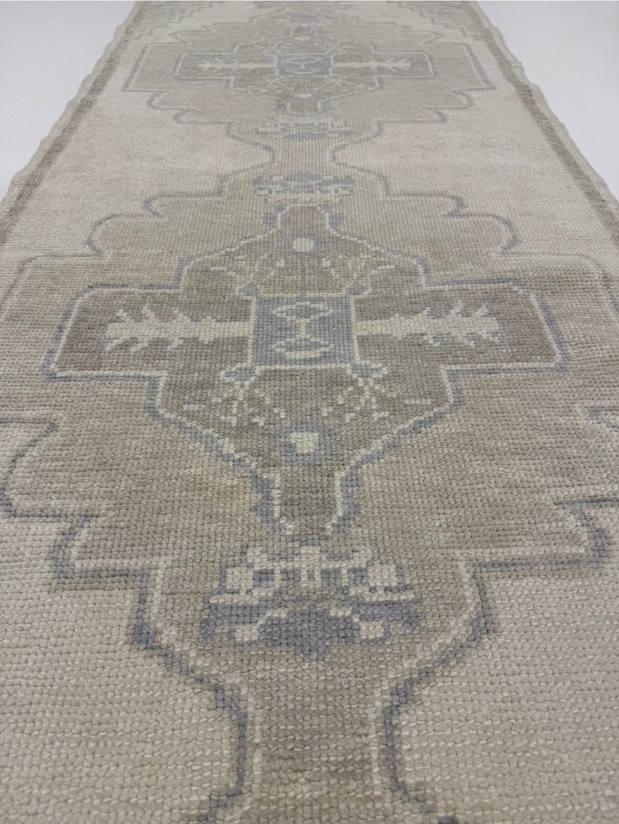  — warm gray wool with tan and gray-blue accents, hand-knotted in Turkey, custom sizes available