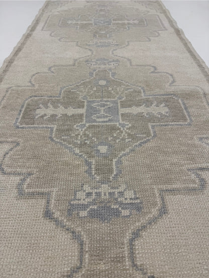  — warm gray wool with tan and gray-blue accents, hand-knotted in Turkey, custom sizes available
