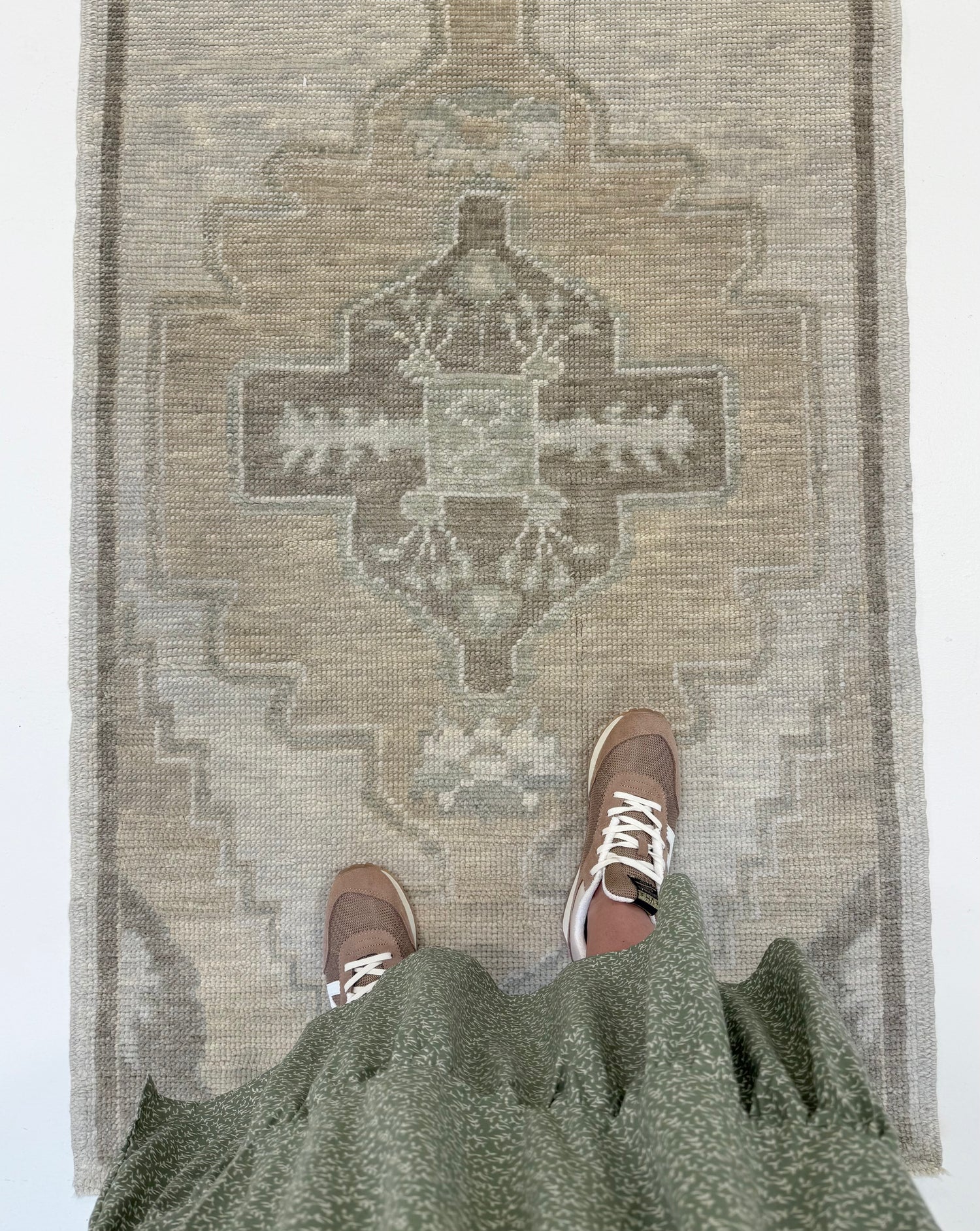 Bethany Turkish Oushak runner in warm gray with tan accents, with a person standing on it
