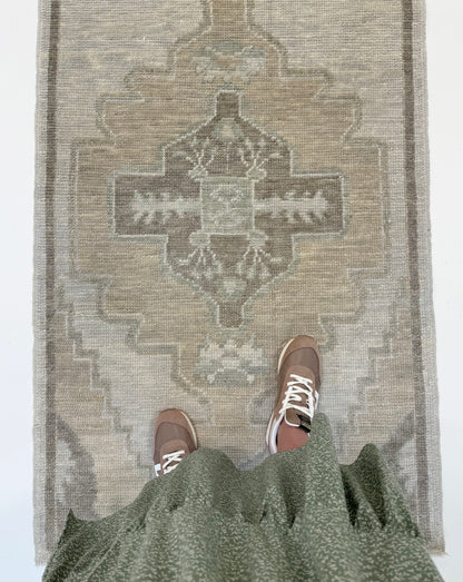 Bethany Turkish Oushak Neutral Runner with person standing on in Fairhope, Alabama.