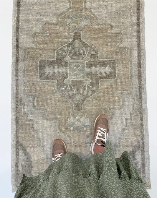 Bethany Turkish Oushak Neutral Runner with person standing on in Fairhope, Alabama.