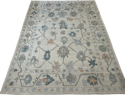 Olivia off-white Turkish Oushak rug with teal, muted orange, gray, light blue, and brown accents, hand-knotted wool