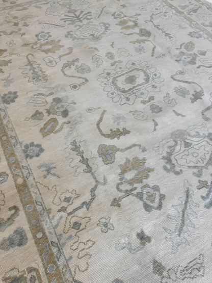 Kendal cream modern Oushak rug with light blue, tan, brown, and soft green accents, hand-knotted wool