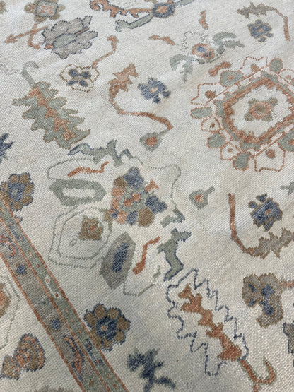 Neutral Turkish Oushak Rug with blues, greens, and oranges closeup in Fairhope, AL
