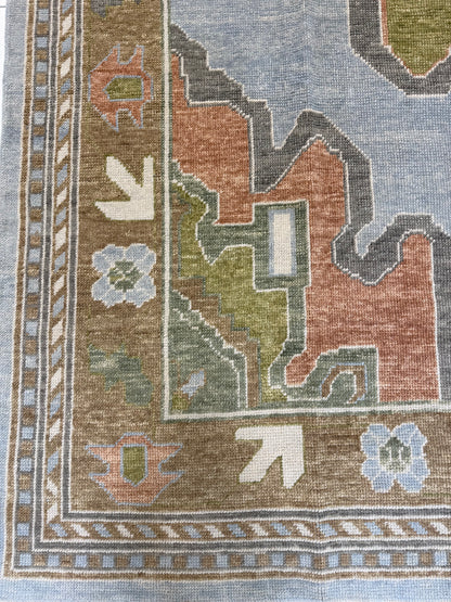 turkish oushak rug with blues, greens, orange and browns