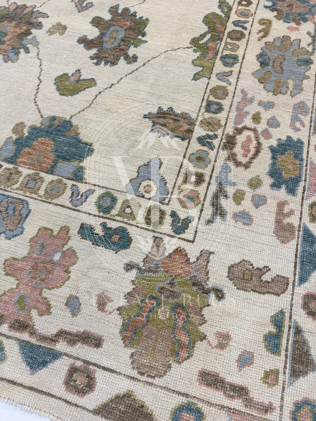 Hand-knotted Palmer Turkish Oushak rug with a soft neutral base and matching neutral border colorful accents featuring turquoise, salmon, chartreuse, light blue, and warm brown accents in a modern, colorful pattern—perfect for living rooms, bedrooms, nurseries, and dining spaces.