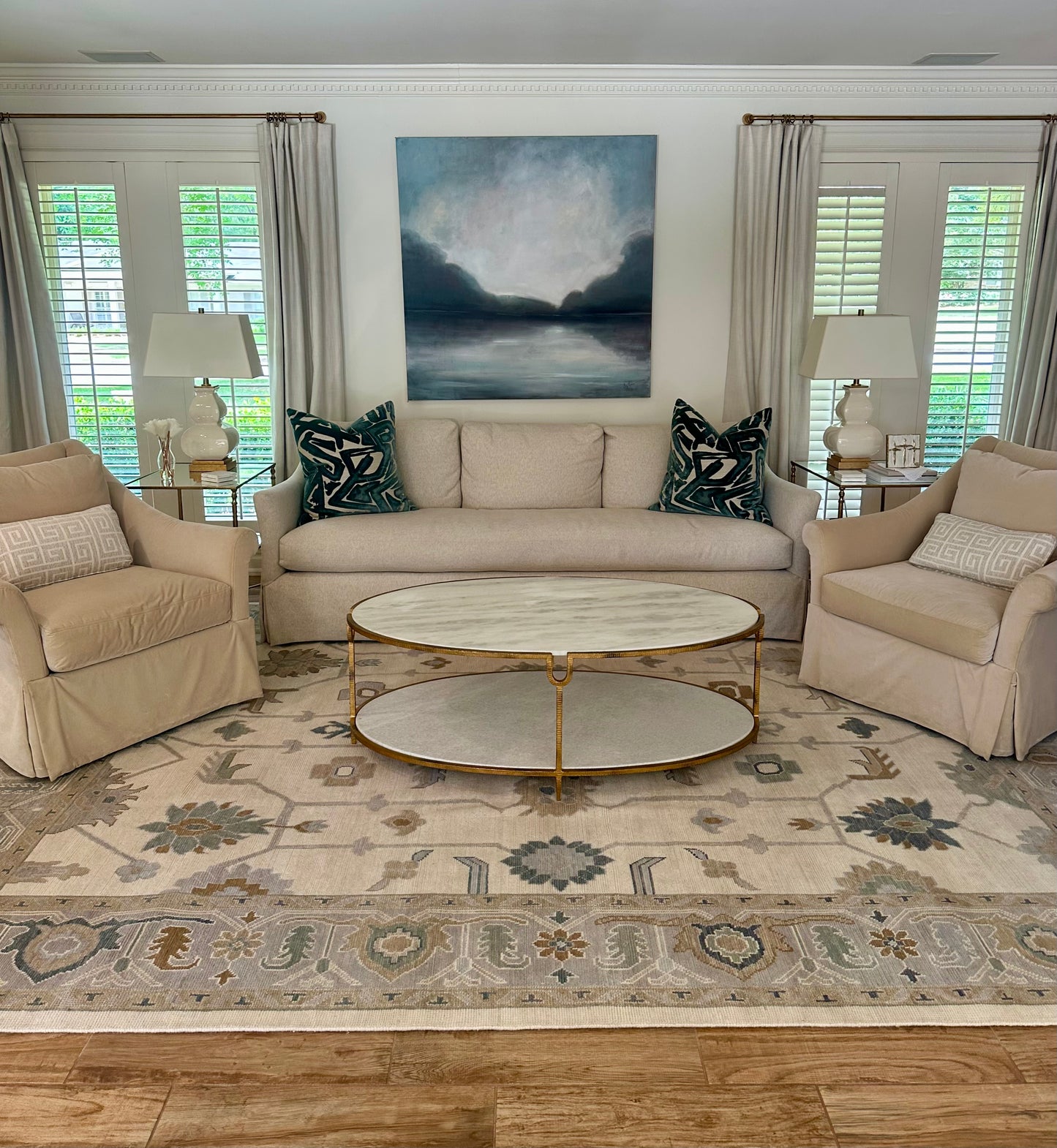 Emory Cream and Blue Modern Oushak in Living Room with blue and white art