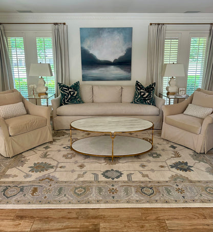 Emory Cream and Blue Modern Oushak in Living Room with blue and white art